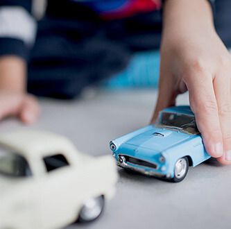 Boy playing with cars.
